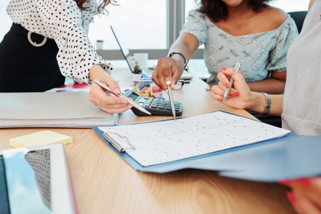 Businesswomen pointing at sales statistics chart