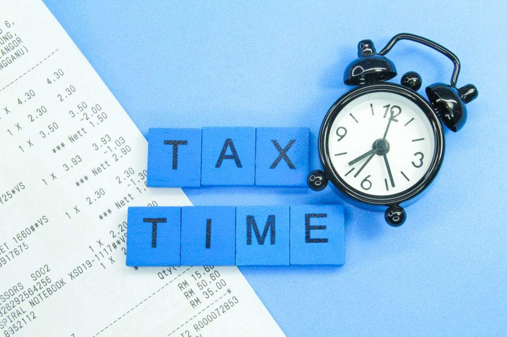 receipts and clocks with the word tax time.