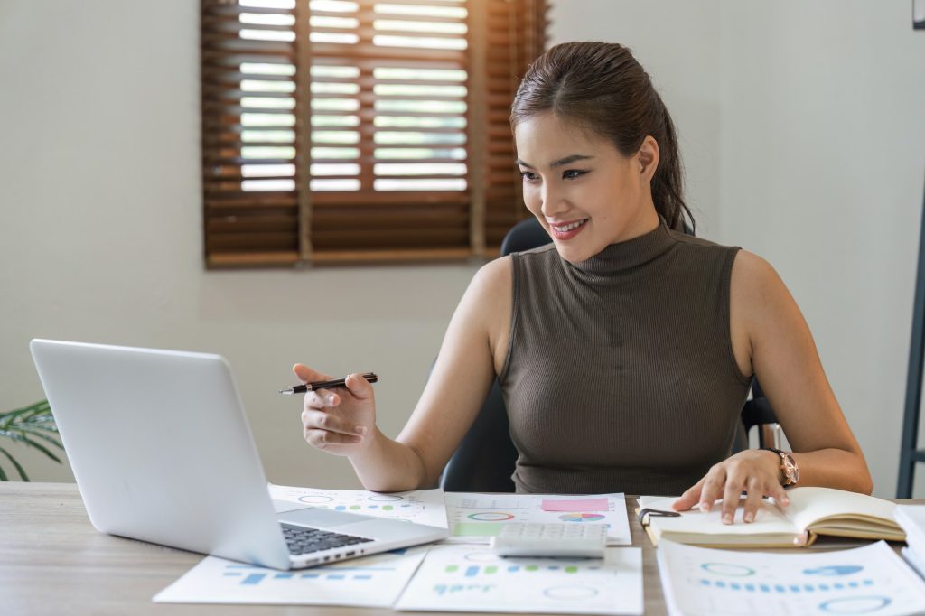 Women sit at home desks, analyzing finances, taxes, investments, paying debts