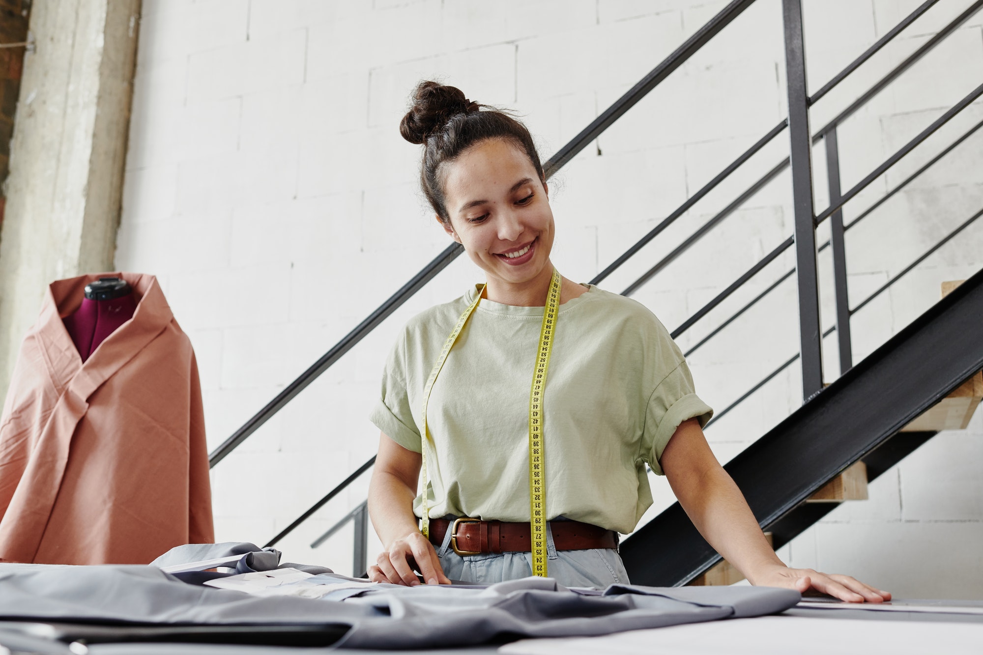 Young self-employed fashion designer or tailor looking through online sketches